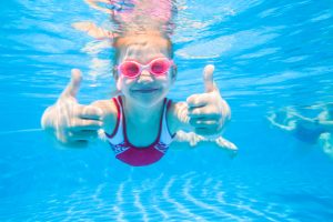 Little,Girl,Deftly,Swim,Underwater,In,Pool